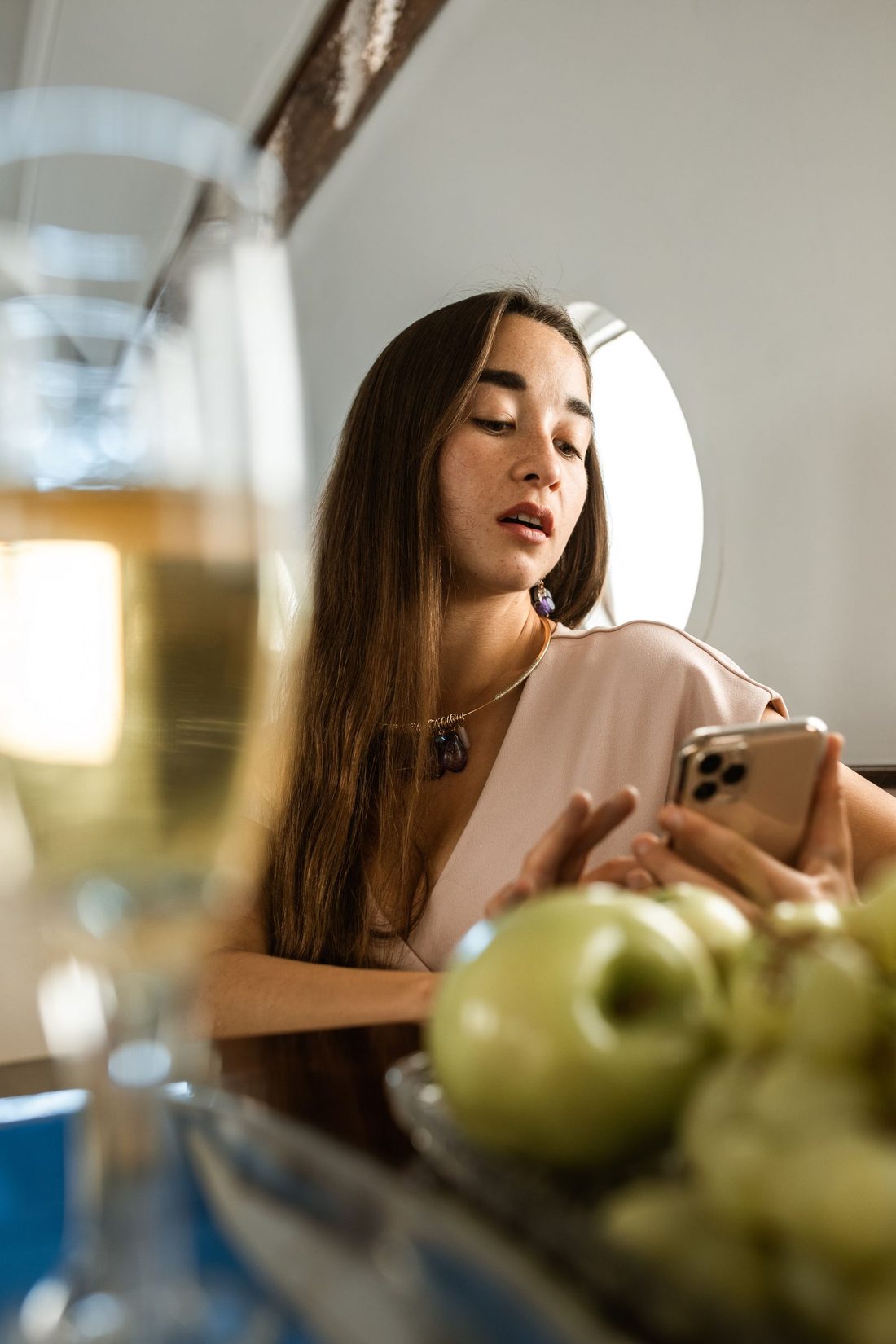 A traveller checking her phone in a private jet cabin